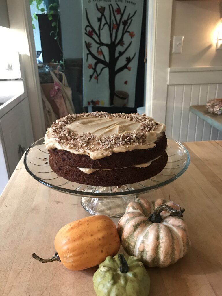 a fall cake on display with little pumpkins