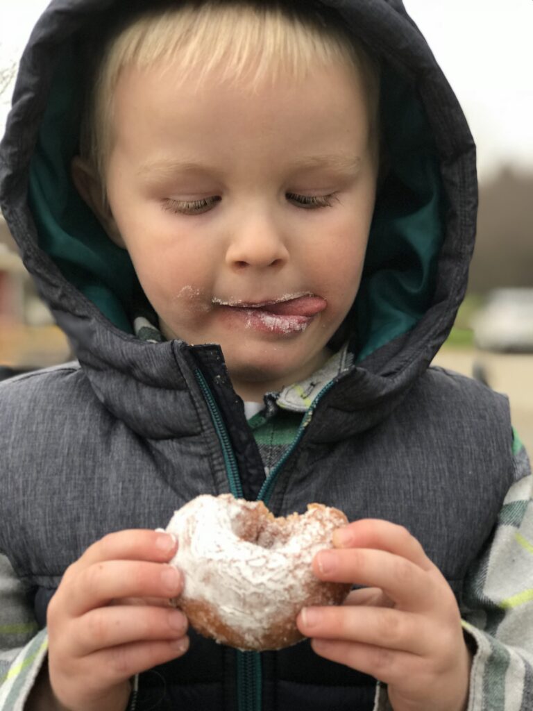 boy eating a donut
