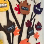 closeup of a felted tree with autumn leaves with notes on them