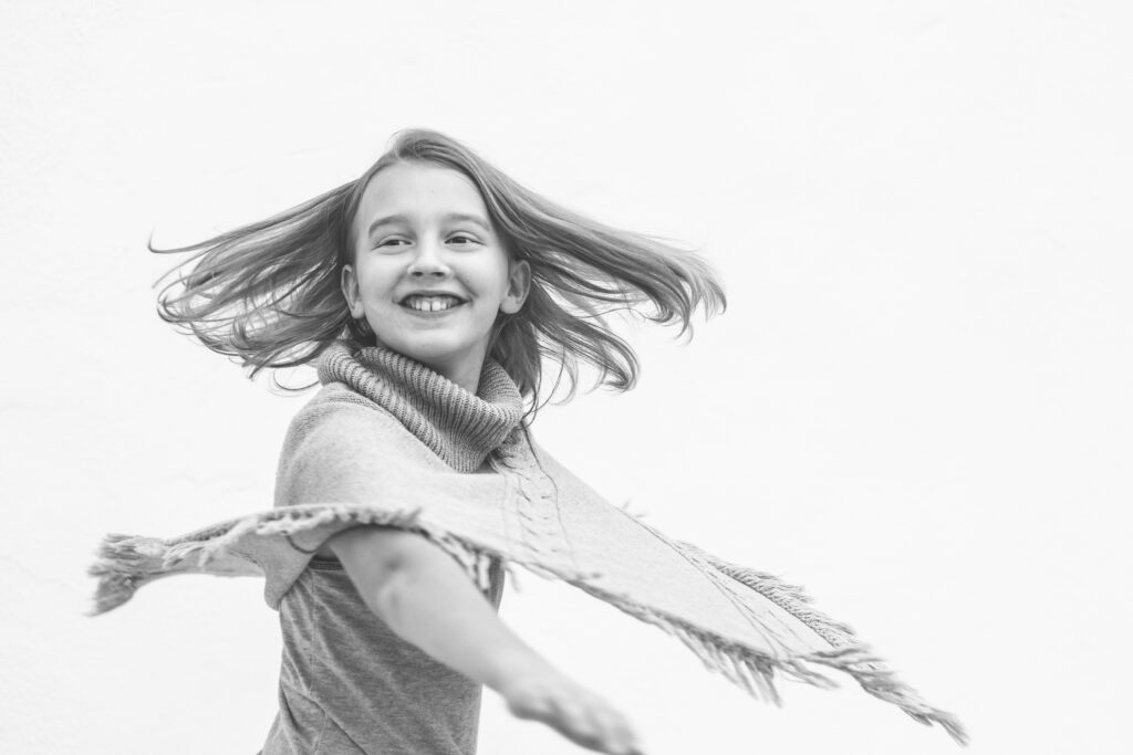 black and white image of girl twirling