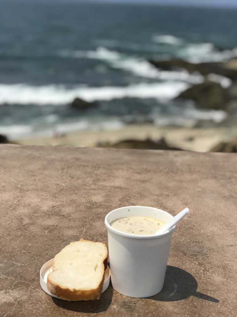 clam chowder and bread by the ocean