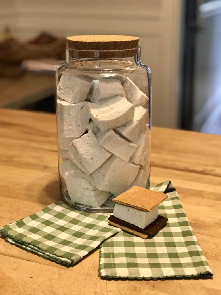 jar of marshmallows with a more on a green and white checked napkin