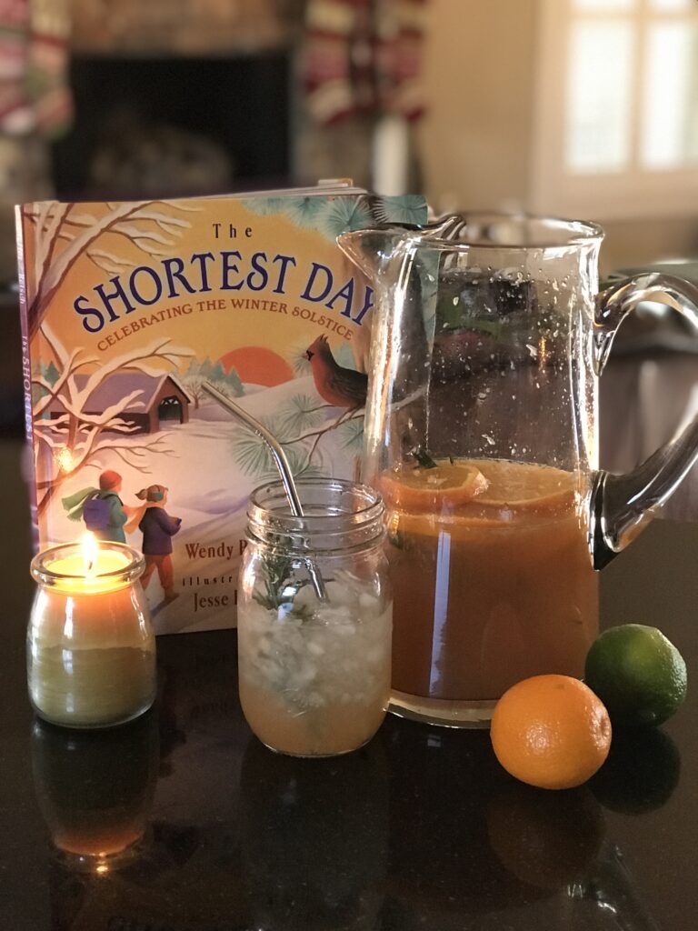 pitcher with juice, book and candle