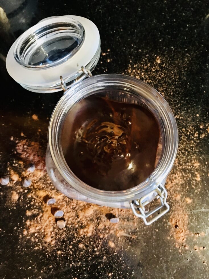 hot fudge sauce on a black counter in an open jar