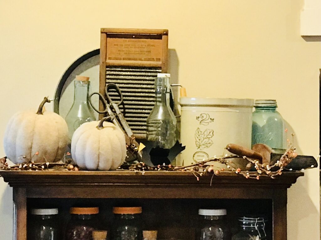pumpkins, washboard, tray, crock, aqua glass on shelf