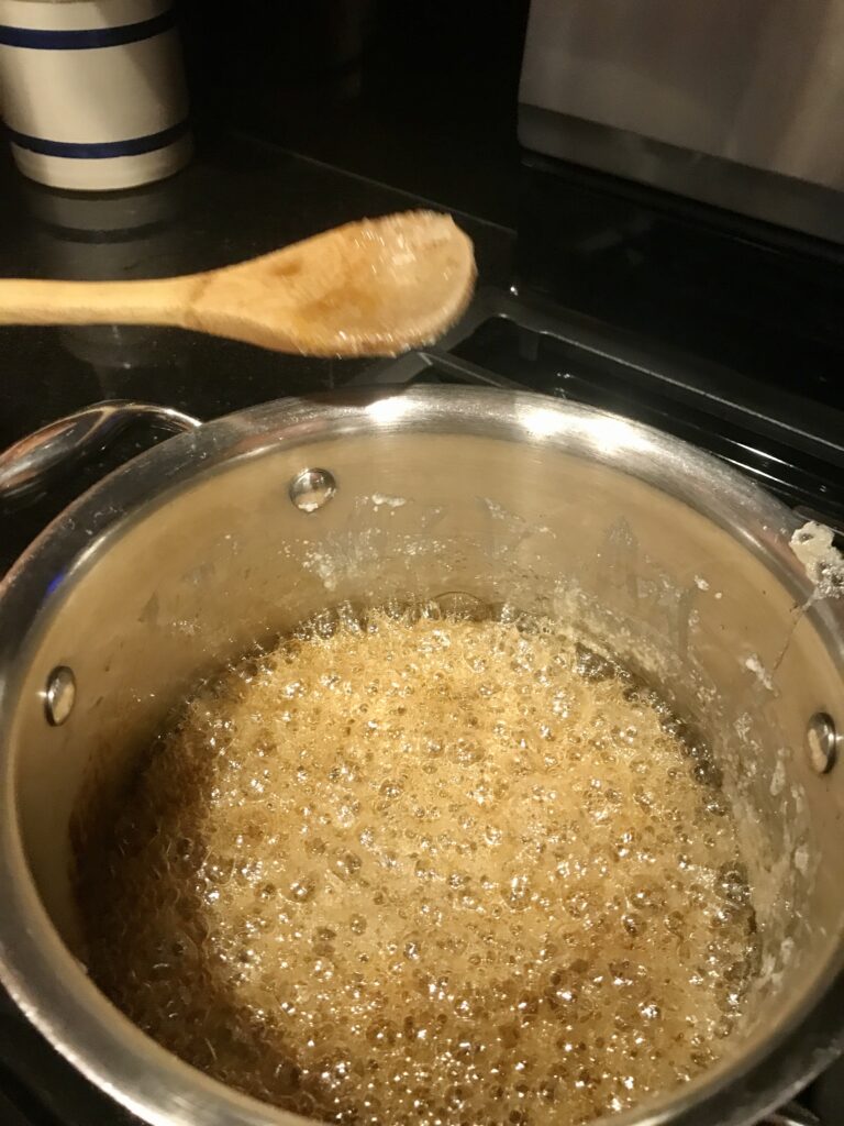 bubbling caramel in a pan with spoon