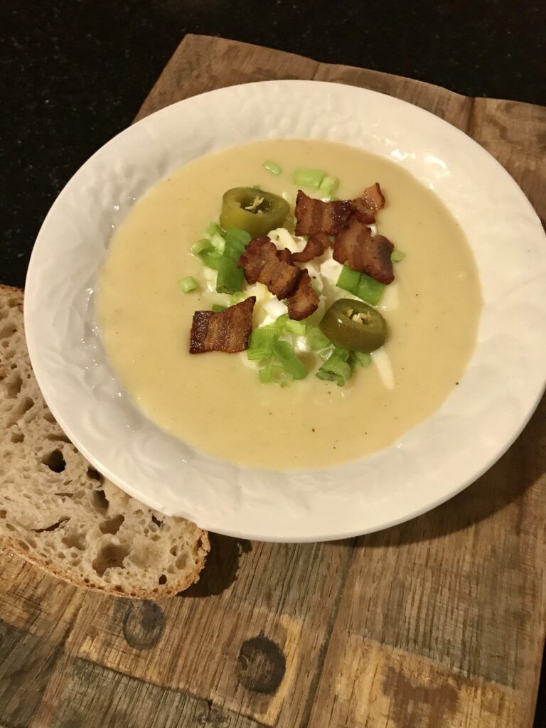 bowl of soup with garnishes and bread