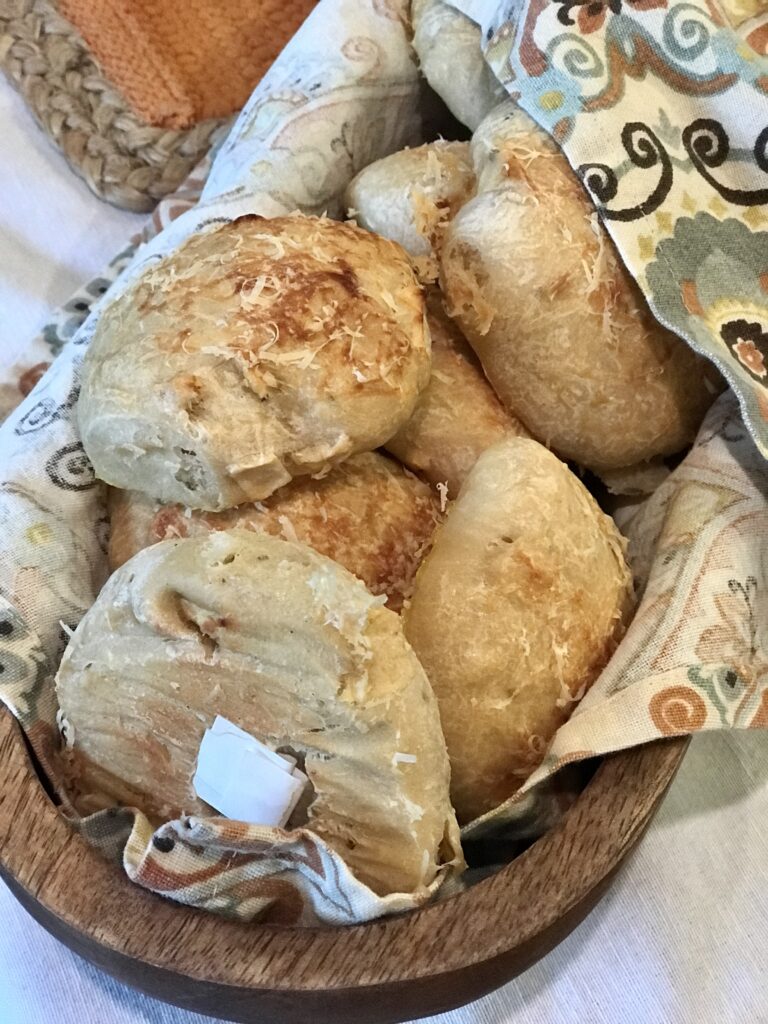 dinner rolls in a wooden basket with cloth