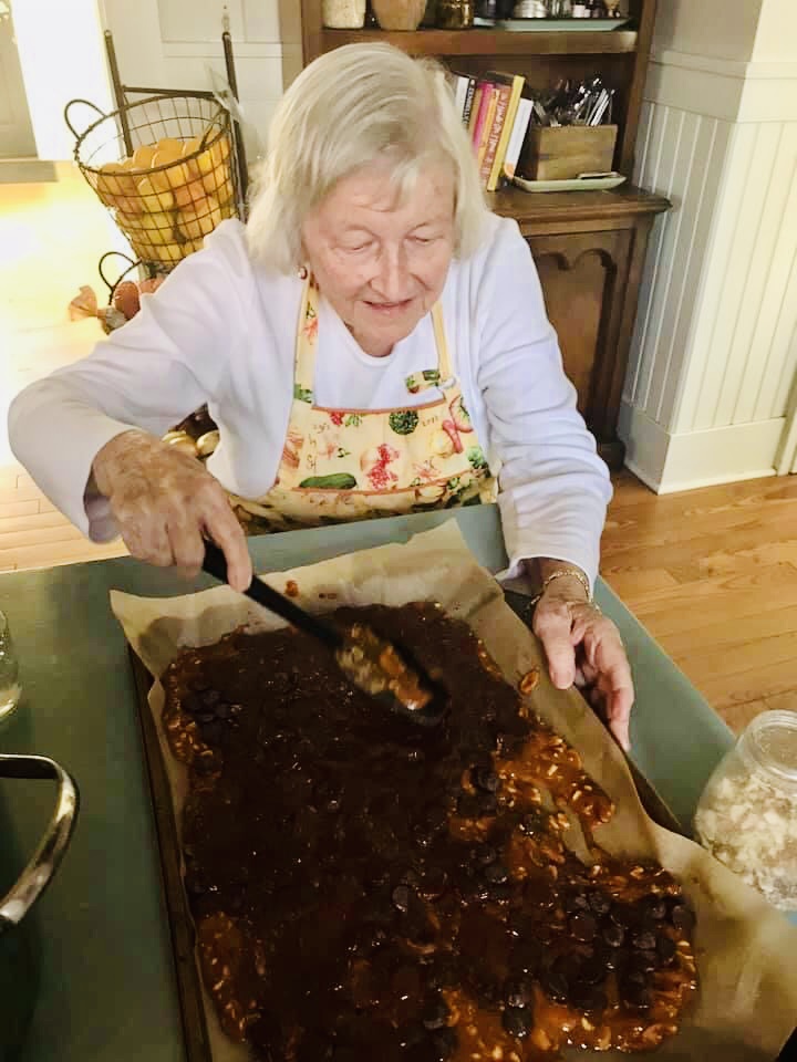 grandma spreading chocolate on nut crunch