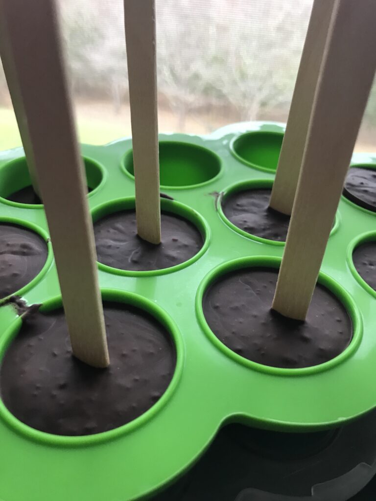 hot chocolate on a stick in a green silicone mold