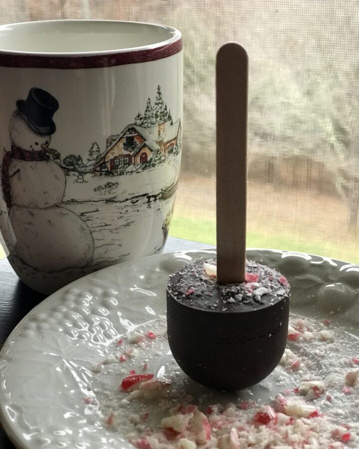 snowman mug with a hot chocolate on a stick