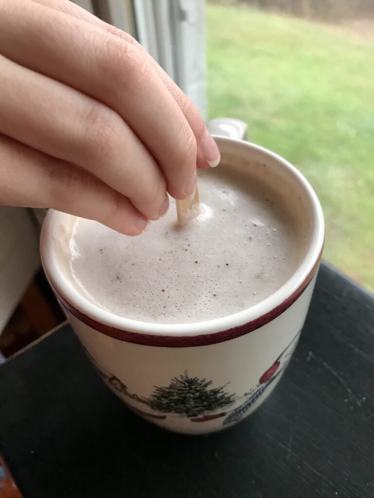 hand stirring hot chocolate