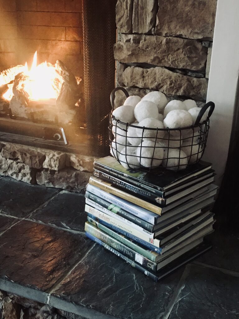 snowballs by the fire on a stack of books for winter decorating