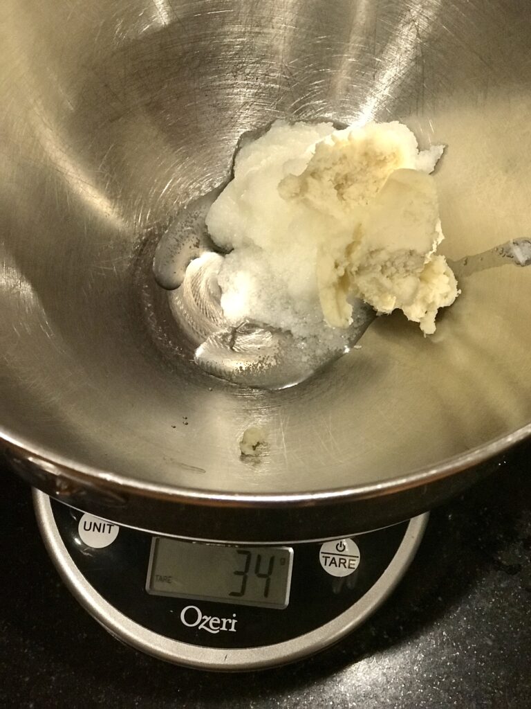weighing the tallow and shea butter on a scale