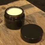 single jar of winter tallow & honey butter face cream on a wood board