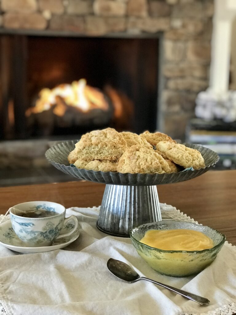 tea and scones with lemon curd by the fire
