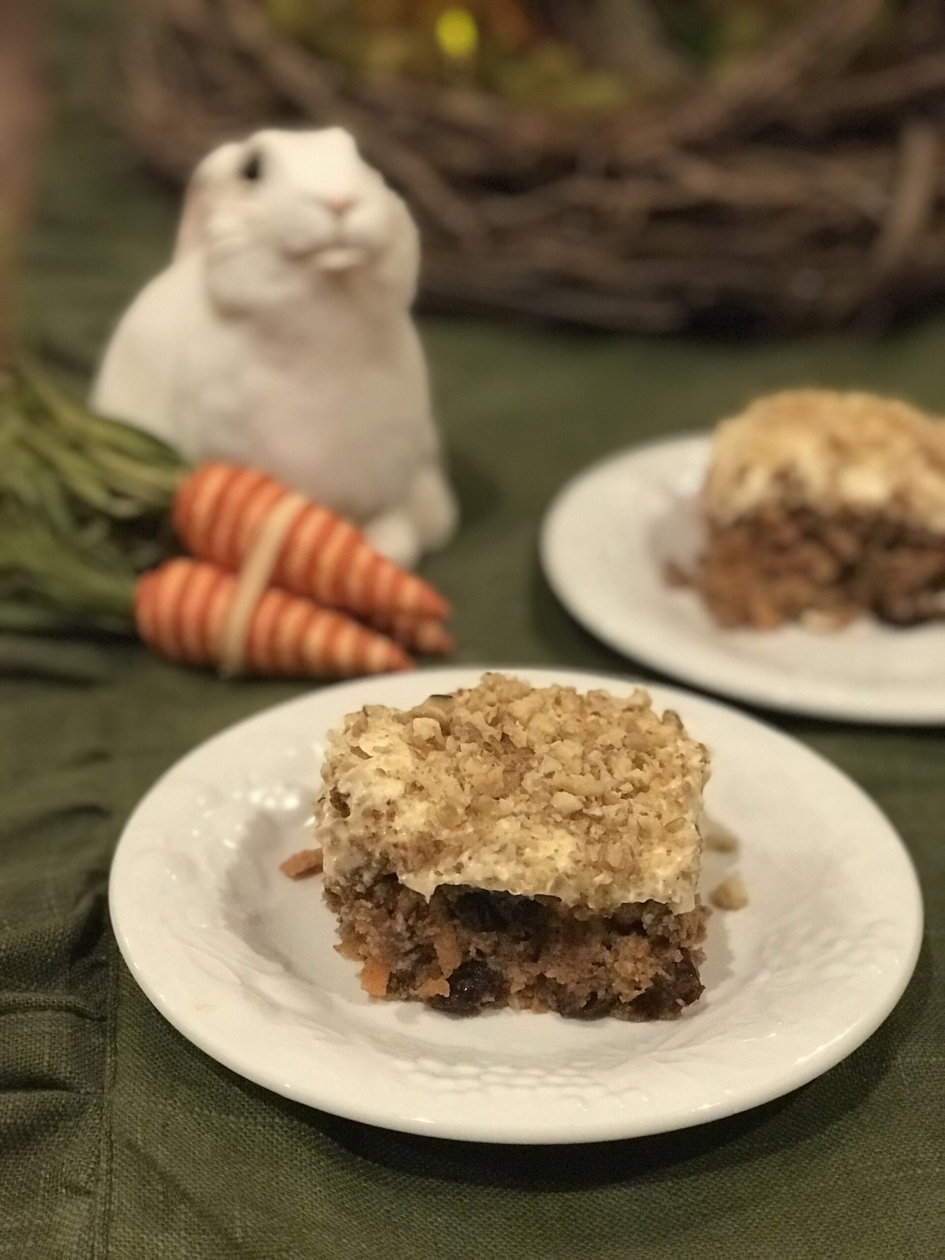 spiced carrot cake with bunny and carrots in the background