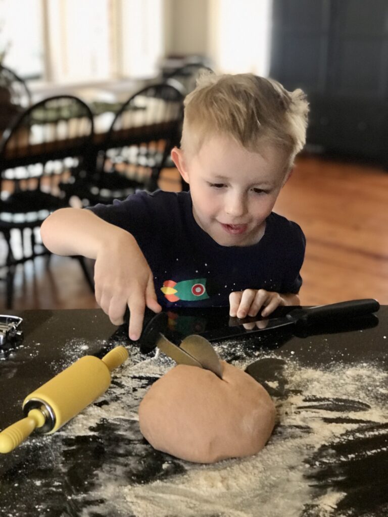 Micah cutting scentsational play dough
