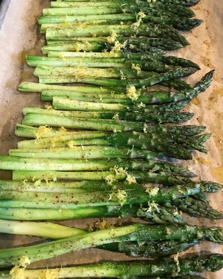 roasted asparagus with lemon on a cookie sheet