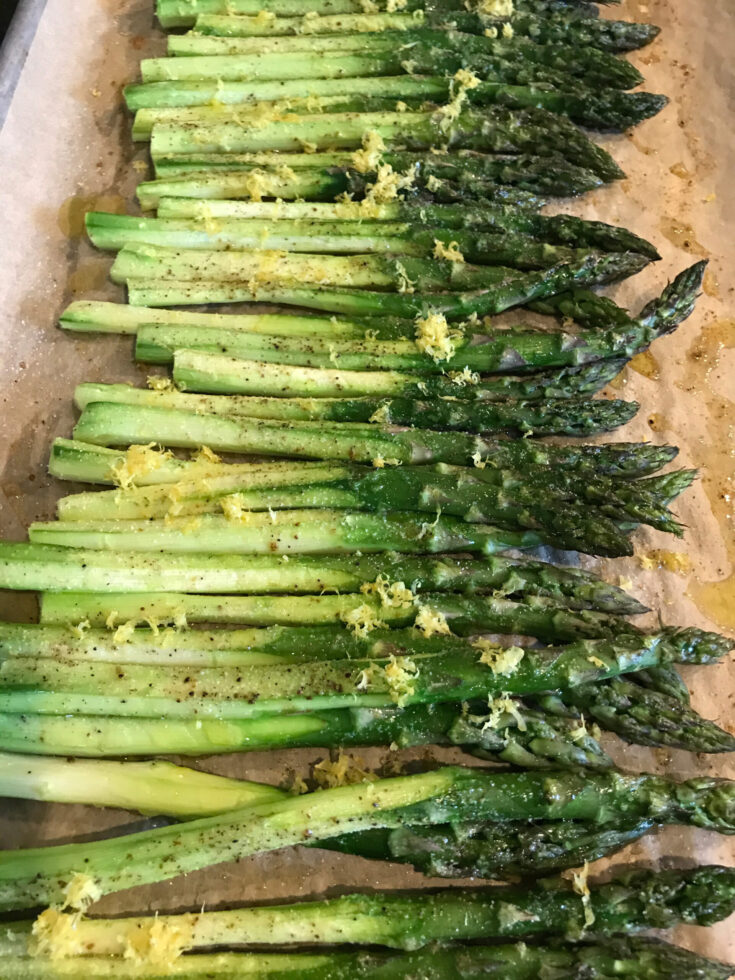 roasted asparagus with lemon on a cookie sheet