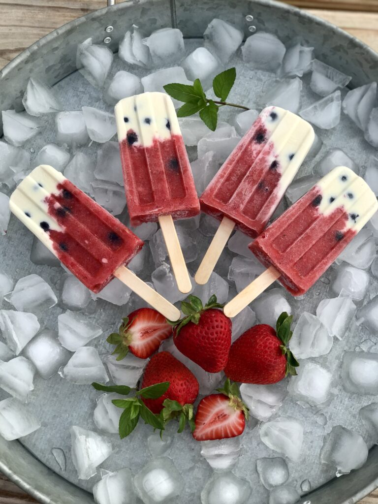 a fan of 4 strawberries and cream pops on ice