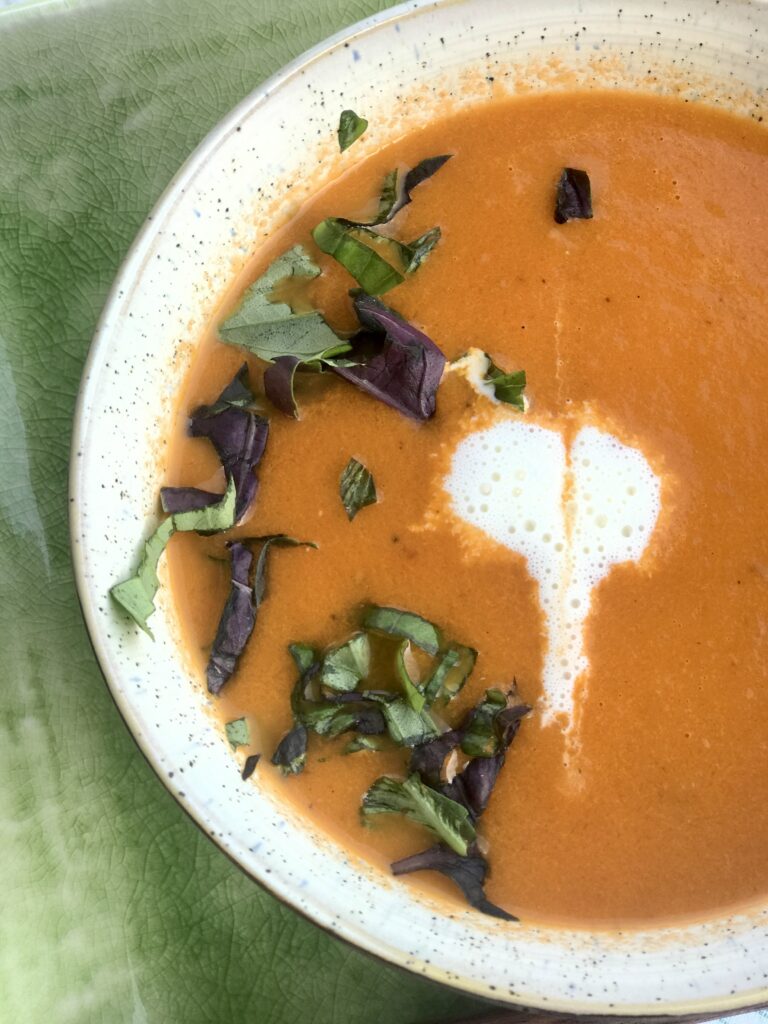a heart decorated on a bowl of roasted heirloom tomato soup