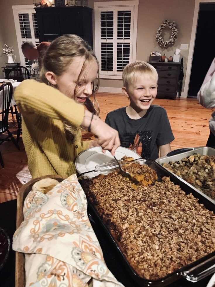 children scooping out Abby's Thankgiving sweet potatoes