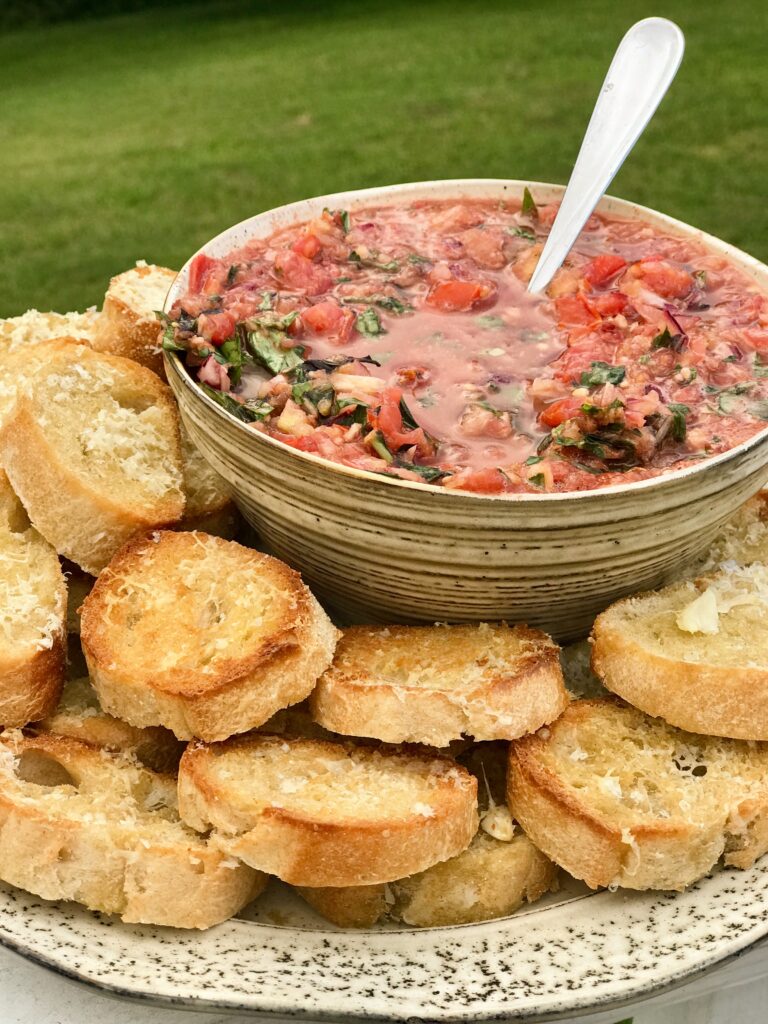a bowl of bruschetta on a bed of toast