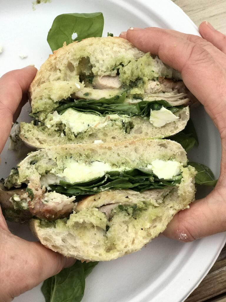 pesto chicken sandwich in hands