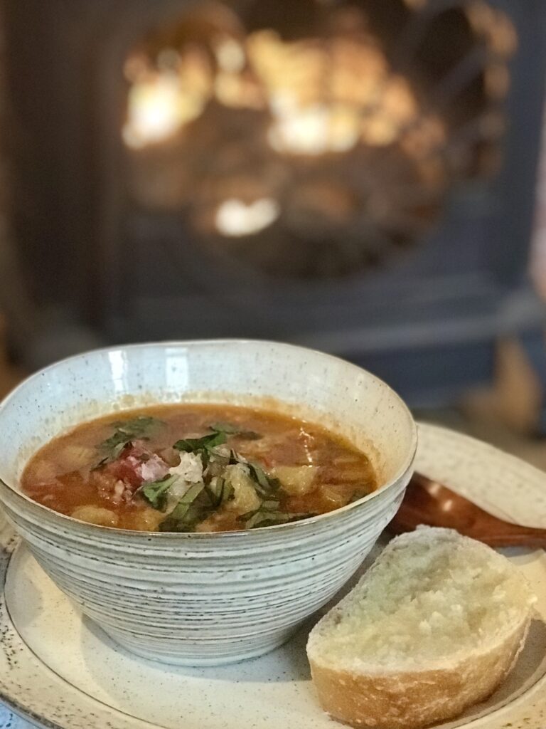 a bowl of bean & farrow soup by the fire