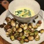 a plate of crispy Brussels sprouts with lemon garlic aioli