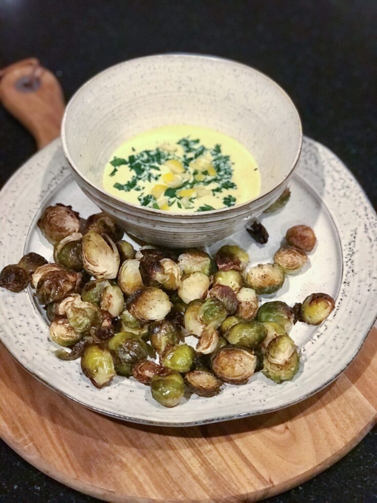 Crispy Brussels Sprouts with lemon garlic aioli on a plate