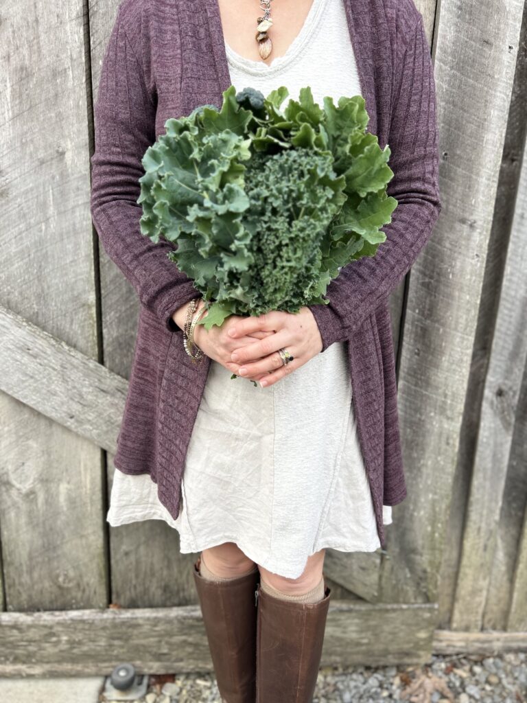 woman holding a bouquet of kale