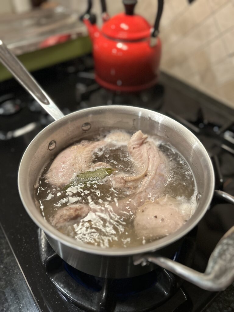 boiling a turkey neck in a pot for stuffing