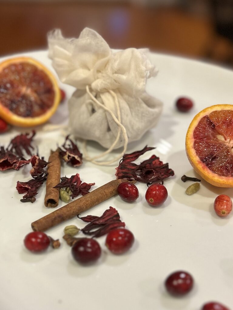 a cheesecloth bundle of spices and hibiscus for the spiced cranberry hibiscus sauce