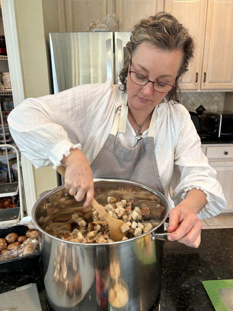 woman stirring stuffing in a large pot