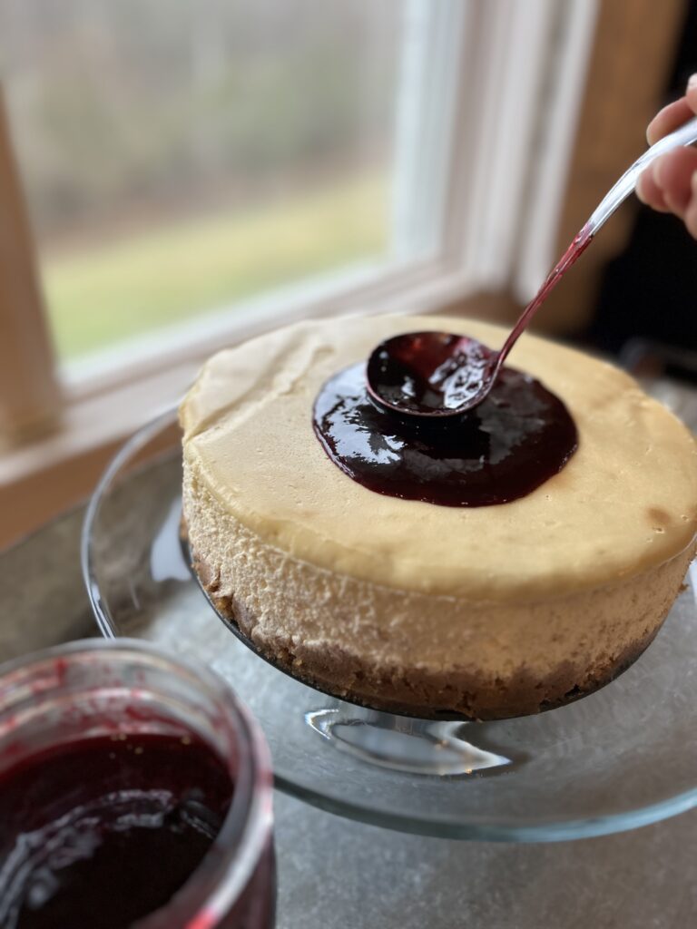berry coulis on cheesecake