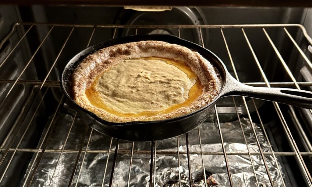 cornbread batter in a skillet in the oven