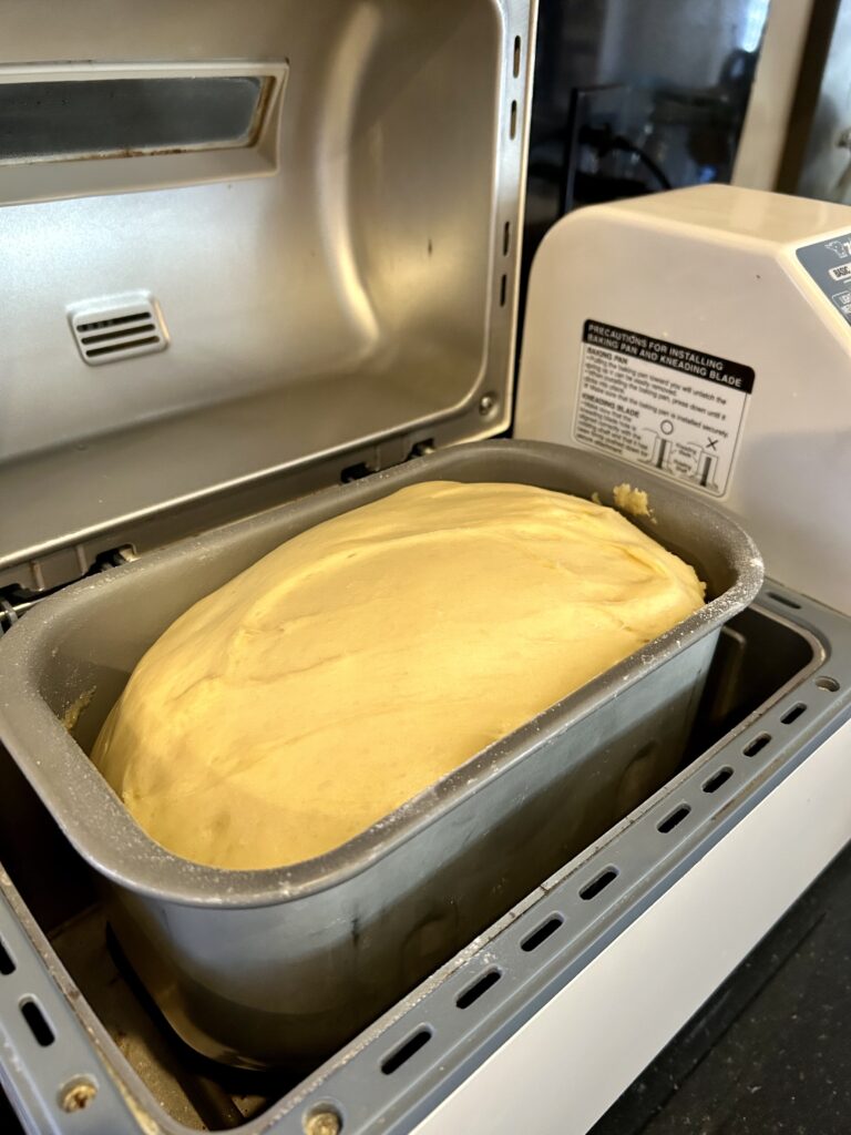 cinnamon roll dough in bread machine after rise