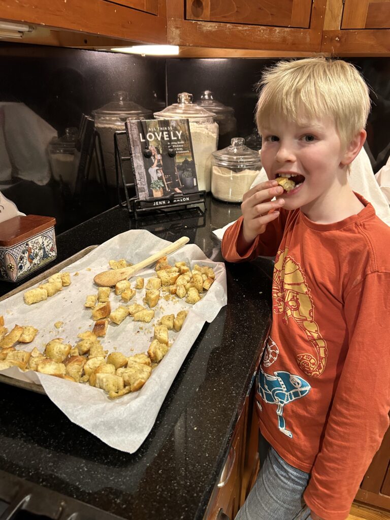 boy snagging some croutons on a tray