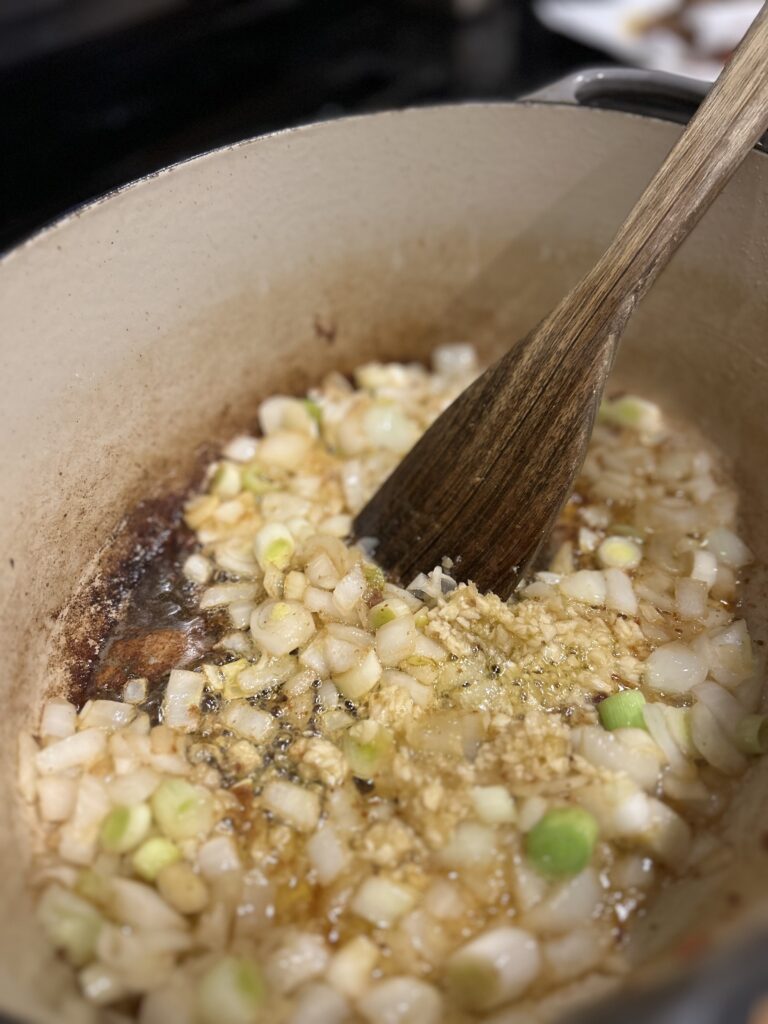 onions, leeks, and garlic sautéing in a pot