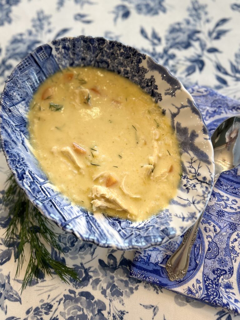 a blue bowl with greek lemon chicken soup