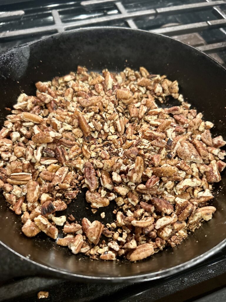 pecans toasting in a cast iron pan