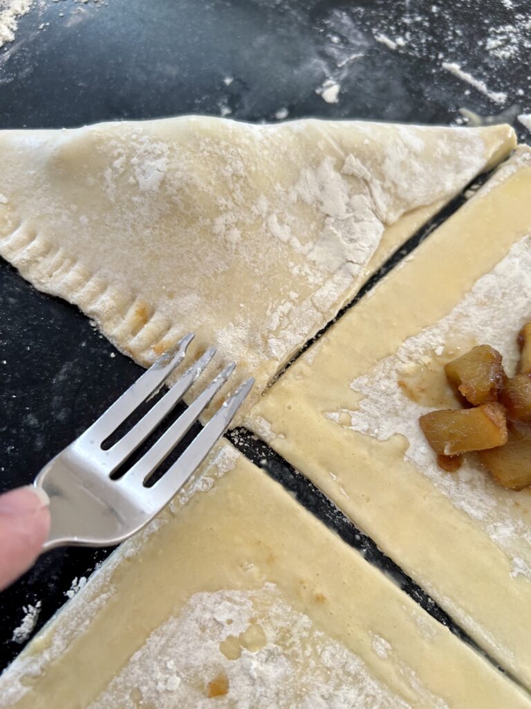 crimping an apple turnover shut with a fork