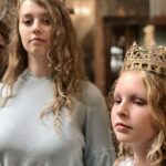 two girls wearing crowns revealing identity