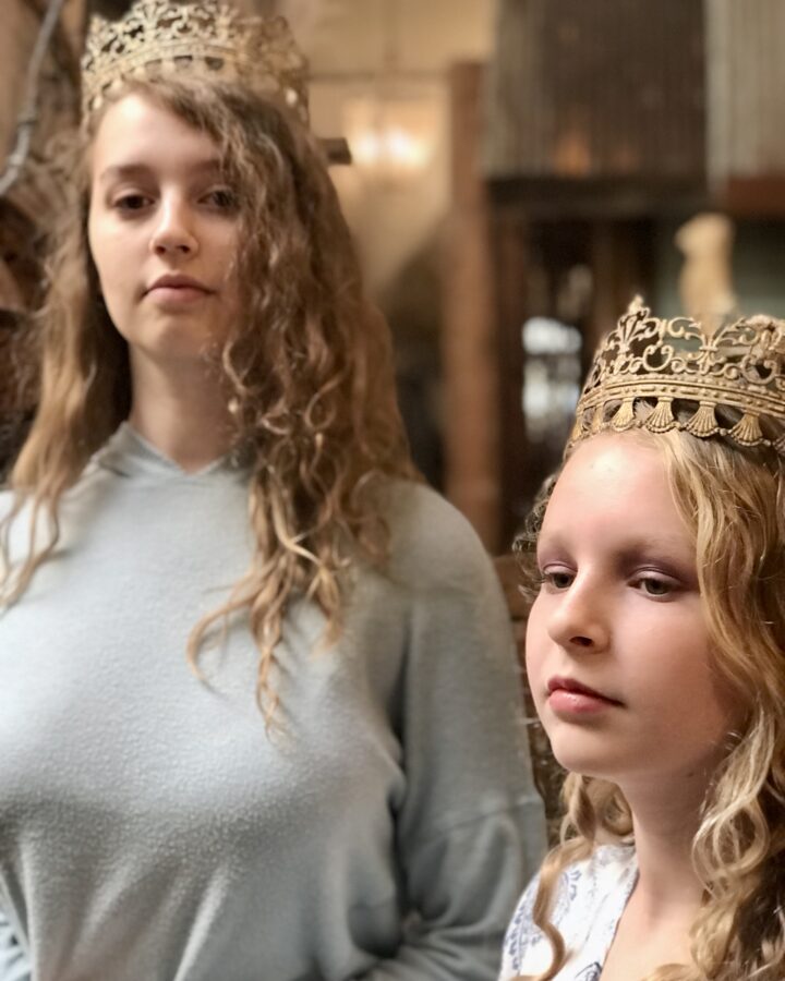 two girls wearing crowns revealing identity